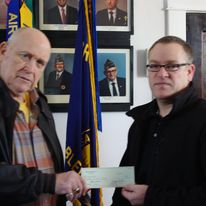 Presenting a donation check in support of local veterans.
